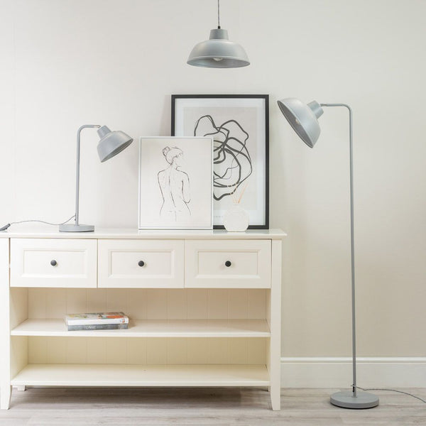 White bookshelf with decorative items and floor lamps in a room.