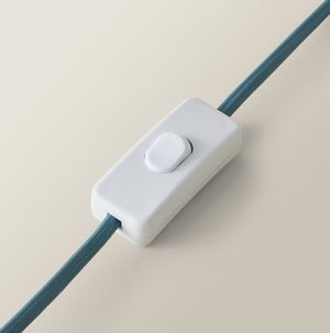 White cable management clip with blue cord on a beige background