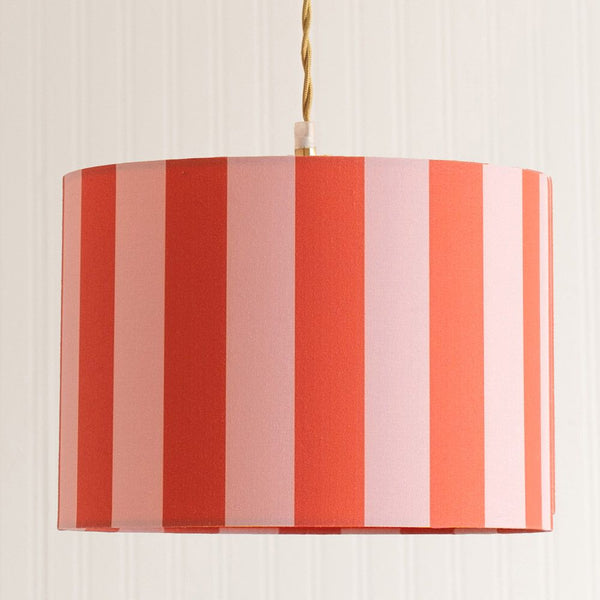 Striped lampshade with red, pink, and white vertical stripes on a beige background