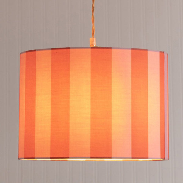 Striped lampshade with orange and red vertical stripes on a plain background