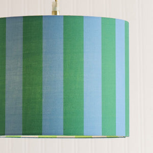 Lampshade with green and blue striped pattern on a white background