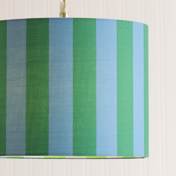 Lampshade with green and blue striped pattern on a white background