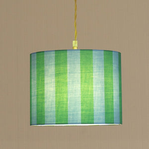 Striped green and blue lampshade on a beige background