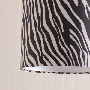 Zebra patterned blind against a neutral wall