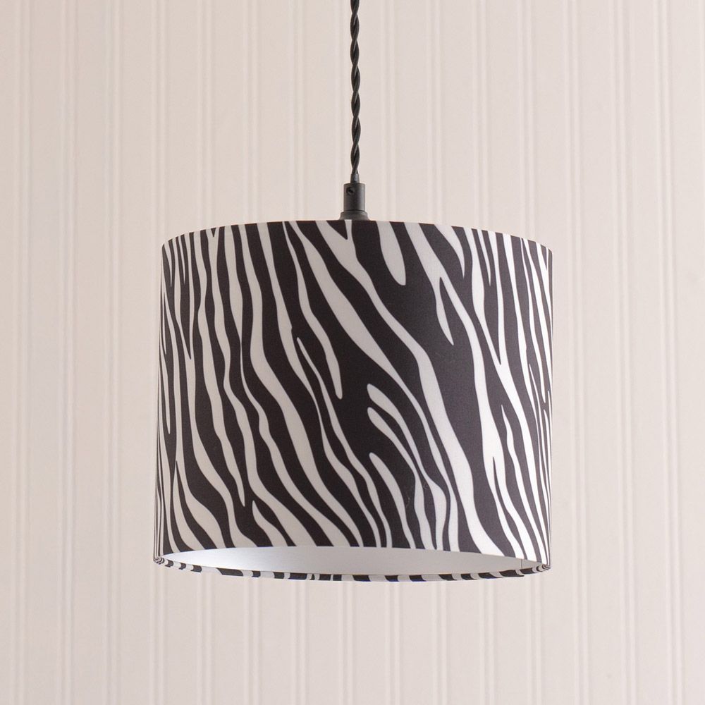 Lamp with zebra pattern shade on a striped wall background