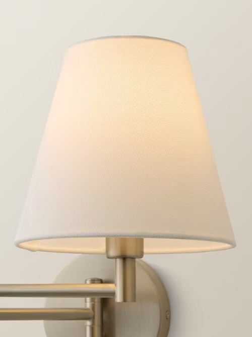 Wall-mounted lamp with a beige shade on a light gray background
