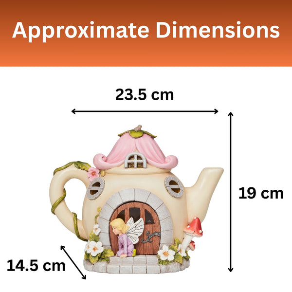 A teapot-shaped fairy house figurine shown with dimension arrows and labels reading 23.5 cm wide, 19 cm tall, and 14.