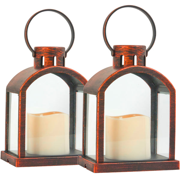 Two matching lanterns with a distressed bronze-brown metal frame, clear glass panels, and cream-colored flameless candles inside, shown on a white background.