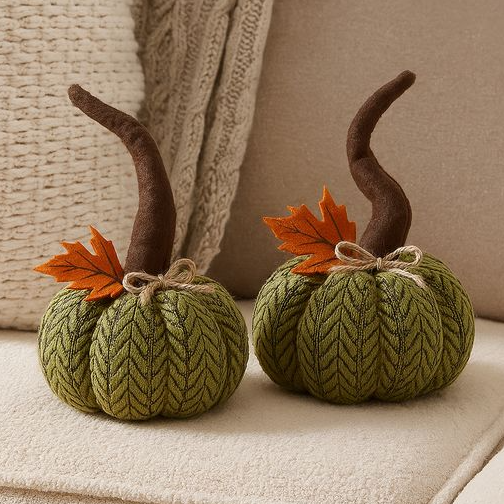 Two small plush pumpkin decorations