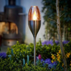 Solar flame stake light illuminated after dark