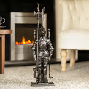 Decorative metal figure of a knight holding a spear in a living room setting with a fireplace.