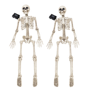 Two plastic skeleton floor decorations with black plastic eyes and black plastic ankles, shown side by side on a white background.