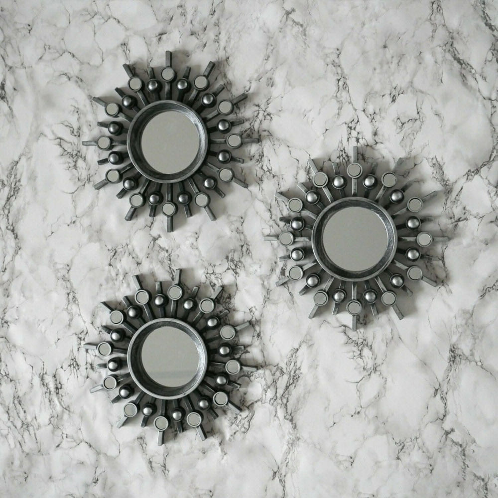 Set of three silver sunburst wall mirrors
