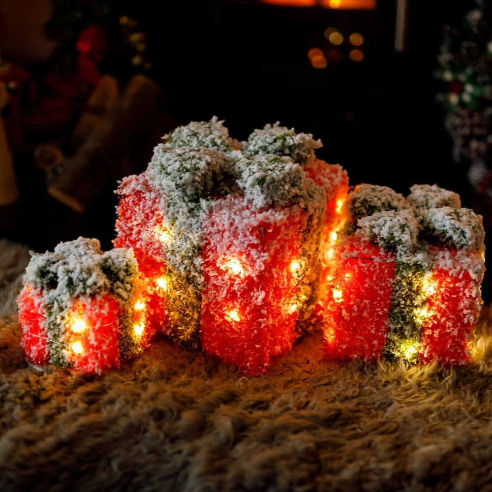 Three red and green frosted LED Christmas gift boxes