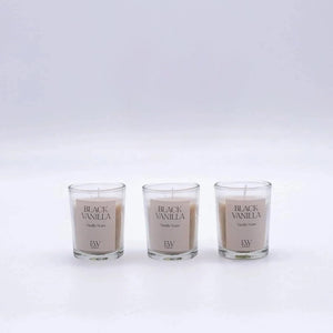 Three 'Black Vanilla' candles with visible labels on a white background
