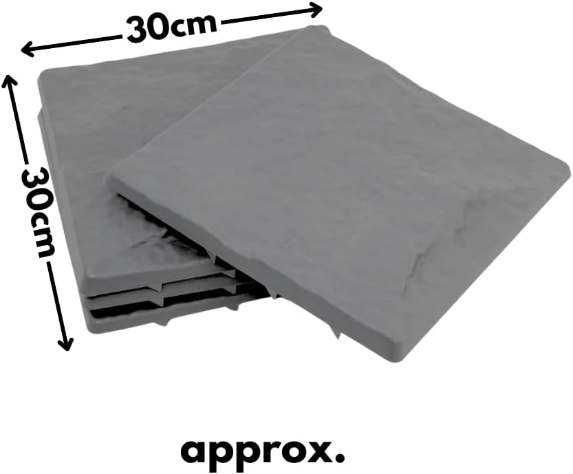 Gray stepping stones arranged in a circular pattern on grass with flowers in the background