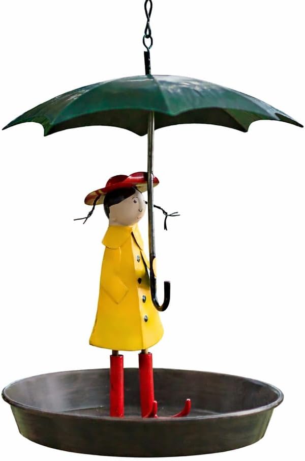Decorative figurine of a person in a yellow raincoat and red boots under a green umbrella on a white background.