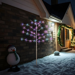 Multicoloured LED lights on white twig tree