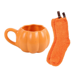 Autumn mug and fluffy socks arranged as a seasonal gift