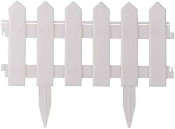 White decorative picket edging around flower bed