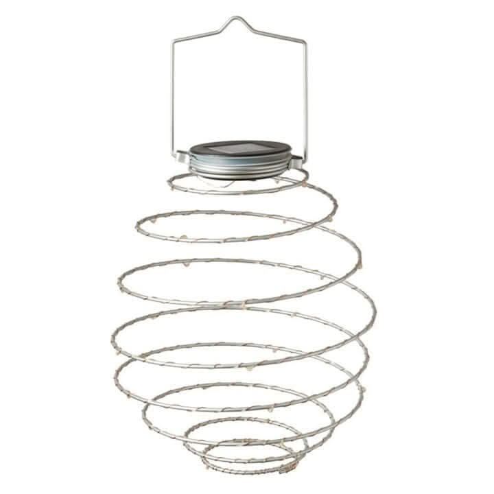 Four copper spiral lights hanging in an outdoor display