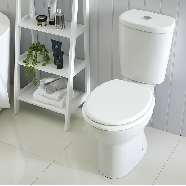 White toilet with a shelf in a bathroom setting