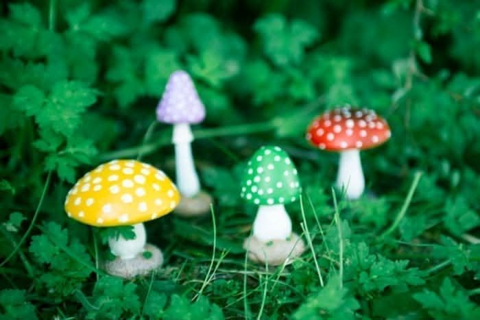 Four colourful resin mushroom garden ornaments in various sizes