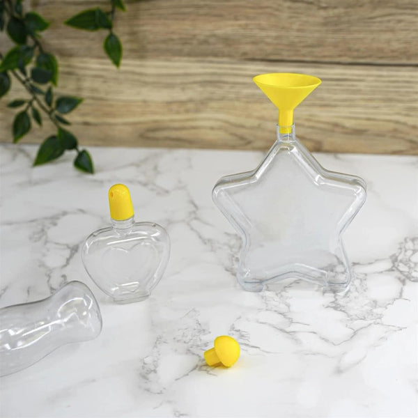 Clear glass bottles with yellow lids on a marble surface