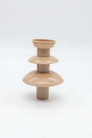 Beige ceramic vase with layered design on a white background