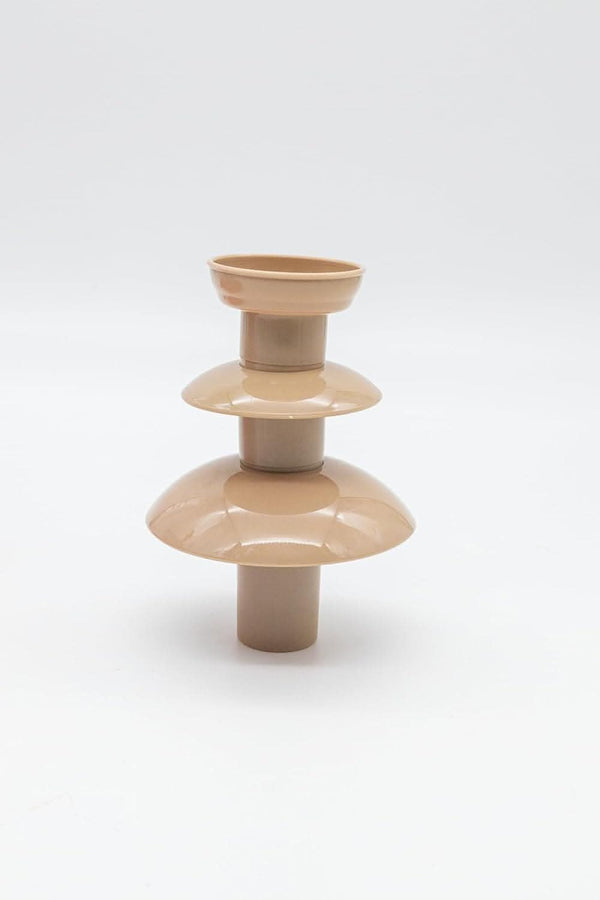 Beige ceramic vase with layered design on a white background