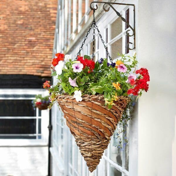 Conical hanging basket with colorful flowers on a building exterior
