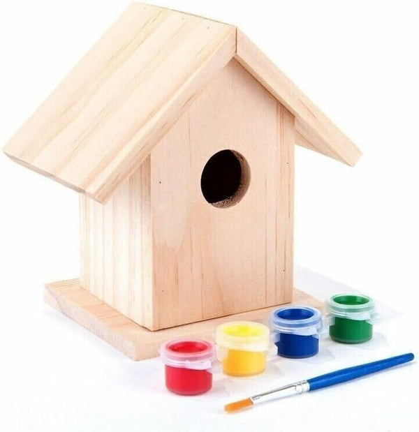 Wooden birdhouse with paint cans and a brush on a white background