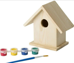 Wooden birdhouse with paint cans and a brush on a white background