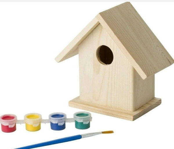 Wooden birdhouse with paint cans and a brush on a white background