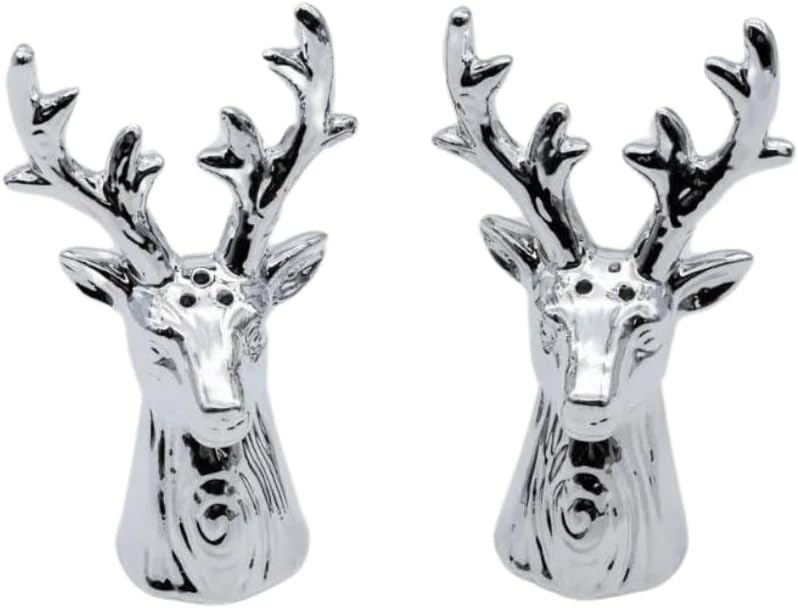 A pair of silver salt and pepper shakers designed to resemble stag heads, placed on a wooden table.