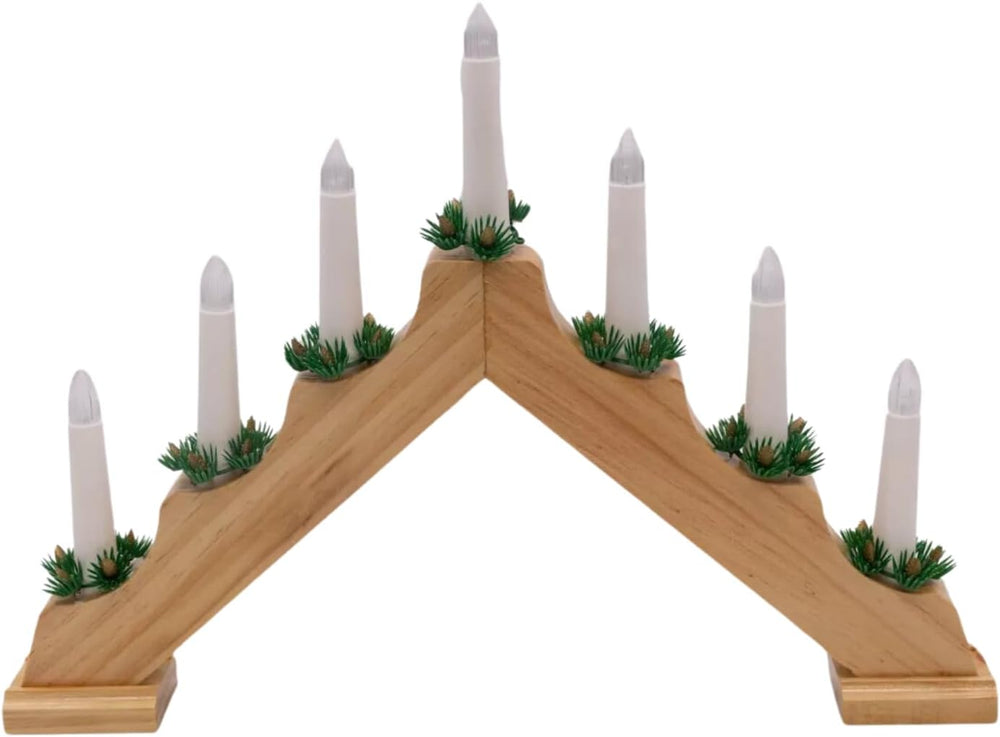Wooden advent candle holder with white candles on a dark surface, blurred lights in the background