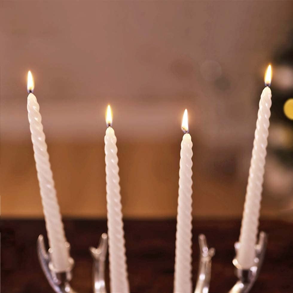 Silver antler-shaped candle holder with four candles on a light gray background