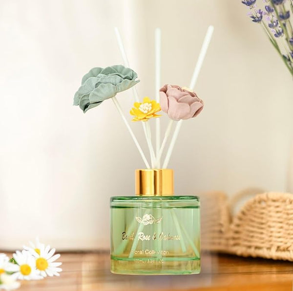 Decorative diffuser with floral elements on a wooden surface