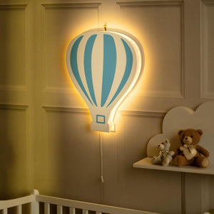Neon hot air balloon light fixture in a child's bedroom with teddy bears on a shelf.