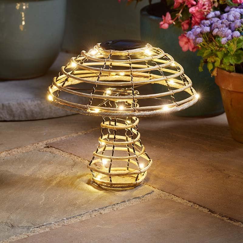 Decorative outdoor light with string lights on a stone surface