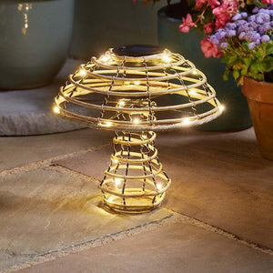 Decorative outdoor light with string lights on a stone surface