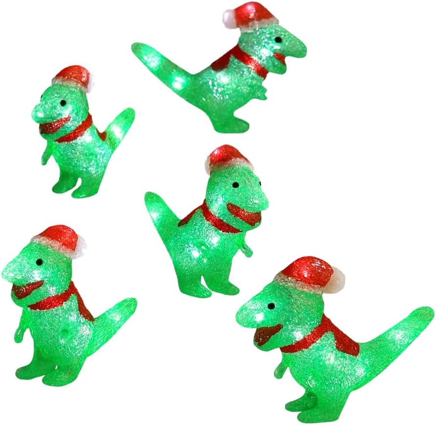 Set of four green dinosaur lights with red Santa hats on grass