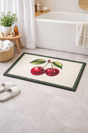 Bath mat with cherry design on a bathroom floor