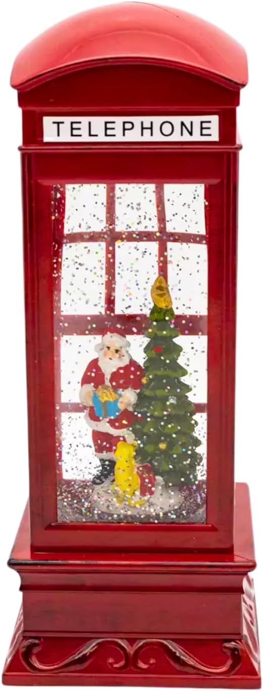 Decorative red telephone booth with a Christmas scene inside, on a wooden surface.
