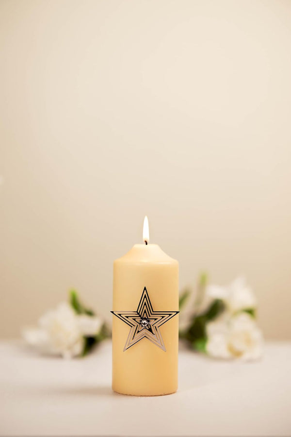 Candle with a star design on a neutral background