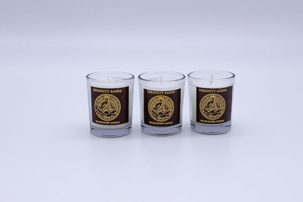 Three glass candles with a logo and text on a white background