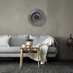 Living room with a gray sofa, wooden side table, and decorative wall clock.
