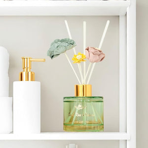 Decorative diffuser with flowers and a bottle on a shelf