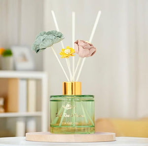 Decorative diffuser with floral elements on a neutral background