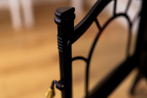 Close-up of a black metal gate with blurred background